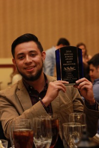 Hector Sifuentes holding his Special Judges Award for Best Presenter