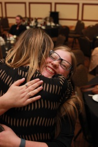 Lauren Friesenhahn (facing) embraces Kelsey Vaeth after the announcement